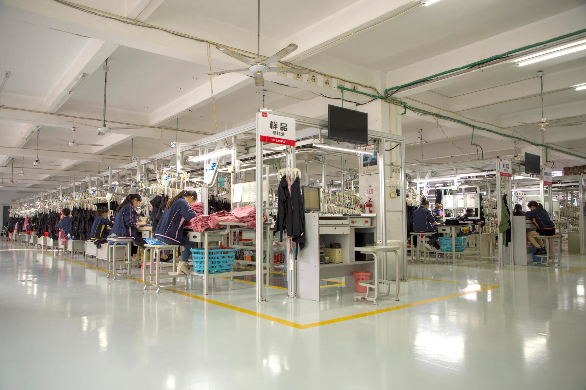 Wide view of the garment production floor and organized sewing workstations